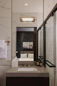 a bathroom with a sink and a large mirror at The Cloud One New York-Downtown, by the Motel One Group in New York