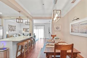 a kitchen and living room with a table and chairs at Coastal Escape in Jewtown
