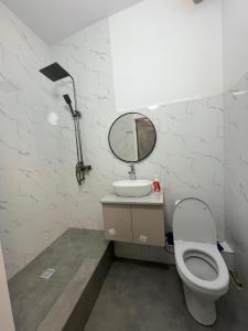 a bathroom with a toilet and a sink and a mirror at Etalon Apartment in Zhezdi