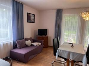 a living room with a couch and a table at Asteria Odargowo in Krokowa