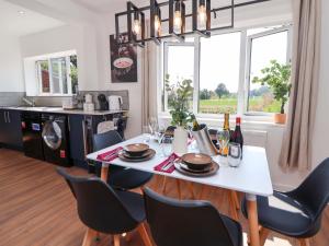a kitchen and dining room with a white table and chairs at Melody Place in Chester