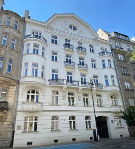a large white building with windows and balconies at La Belle Epoque in Warsaw