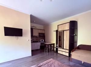 a living room with a couch and a kitchen at Modern Apartments in Mukacheve