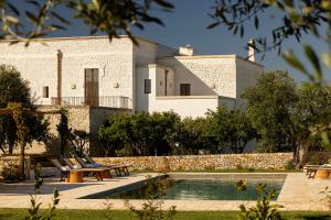 a villa with a swimming pool in front of a building at Masseria Tarsia Morisco in Polignano a Mare