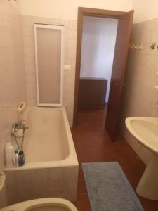 a bathroom with a tub and a toilet and a sink at Villa Luisa in Carovigno