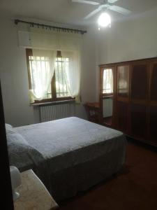 a bedroom with a bed and a ceiling fan at Villa Luisa in Carovigno