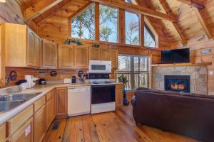 a kitchen with a stove and a fireplace at The Vinson By Avada Properites in Gatlinburg