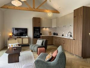 a living room with a couch and a kitchen at 766 - Maison moderne avec piscine privative. in Erquy