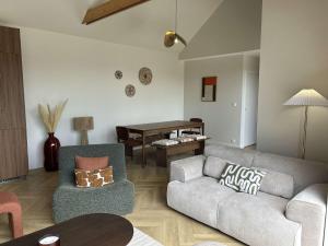 a living room with a couch and a table at 766 - Maison moderne avec piscine privative. in Erquy