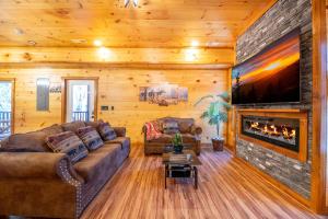 a living room with a couch and a fireplace at Three Little Bears 2 By Avada Properties in Gatlinburg