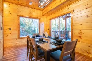 a dining room with a wooden table and chairs at Three Little Bears 2 By Avada Properties in Gatlinburg