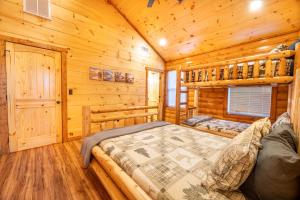 a bedroom with a bed in a wooden cabin at Three Little Bears 2 By Avada Properties in Gatlinburg