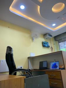 an office with a desk with a chair and a computer at Haya Residency in Mysore