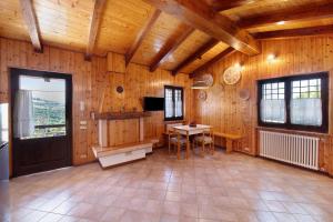 a large room with a table and a tv and wooden walls at Casa delle Delizie in SantʼAmbrogio di Valpolicella +22 photos