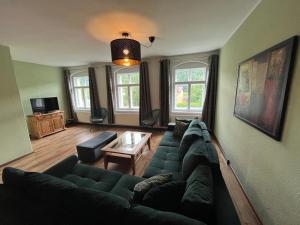 a living room with a couch and a table at Ferienwohnungen Endler in Bad Schandau