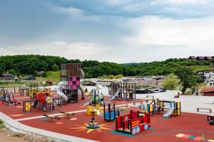 a playground with colorful equipment in a park at Casute Enea Baile Figa cu Aer condiționat in Agrişu de Sus