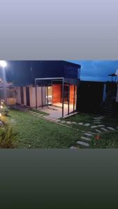 a house with a black roof and a yard at Rain view wayanad in Wayanad