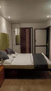 a bedroom with a large bed in a room at Rain view wayanad in Wayanad