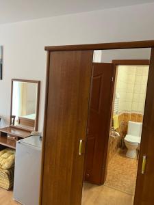 a bathroom with a door open to a bathroom with a toilet at Asteria Odargowo in Krokowa +110 photos