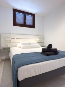 a bedroom with a large bed with a blue blanket at Acapulco Beach in Costa de Adeje +27 photos