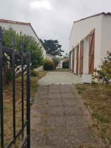 a fence in front of a row of buildings at la brise marine in Saint-Hilaire-de-Riez +5 photos