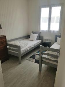 a bedroom with a bed and a window at la brise marine in Saint-Hilaire-de-Riez