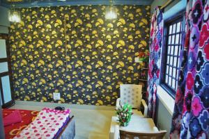 a room with a wall with yellow hats on it at Rustic Retreat Homestay Deluxe Mountain view Room in Srinagar