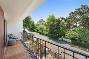 a balcony with a view of a street at - Villa Alizee - Luxe en charme in pittoresk De Haan in De Haan