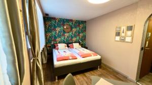 a small bedroom with a bed with two pillows at Gästehaus Grüner Baum in Sankt Martin