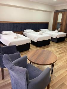 A bed or beds in a room at Türkler Suite Hotel