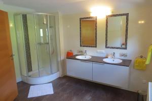 a bathroom with two sinks and a shower at Ferienhaus Anke - Ausseerland Salzkammergut in Pichl bei Aussee +64 photos