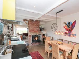 a kitchen and living room with a table and a fireplace at Sea Haven in Filey