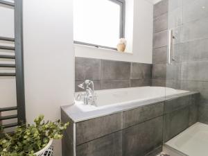 a bathroom with a tub and a sink at Sea Haven in Filey +30 photos