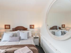 a bedroom with a large mirror and a bed at Sea Haven in Filey