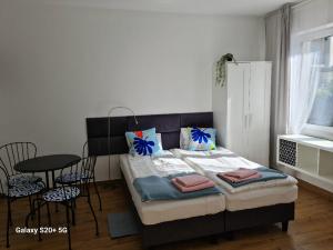 a bedroom with a bed and a table and chairs at Apartamenty Dana in Pustkowo