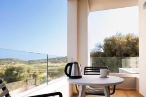a table and chairs in front of a large window at Maradiva View in Villasimius