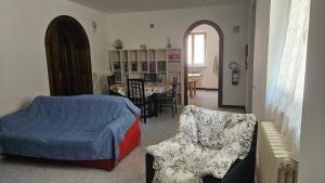 a bedroom with a bed and a chair and a table at L' oasi del riposo in Baschi