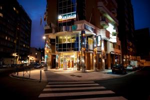 a tall building with a sign on it at night at At Home Appart Hotel in Toulouse