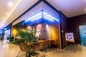 a restaurant with a table and chairs in a building at 2 Bedroom Green Yellow luxury 5549 Makati 300Mb swim in Manila +91 photos