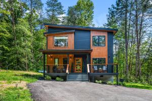 a tiny house in the woods with a driveway at Luxe 634 By Avada Properties in Pigeon Forge