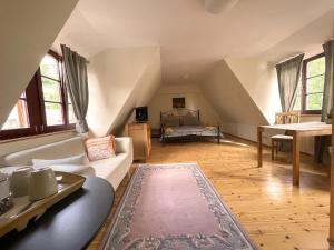 a living room with a couch and a bed at Pension am Markt Meißen in Meißen