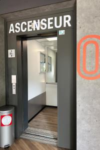 an entrance to an entrance to an aspen store at ibis budget Angoulême Centre in Angoulême