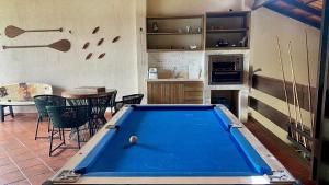 a kitchen with a pool table in a room at Casa Vista da Ilha in Alter do Chao
