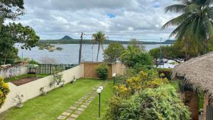 a garden with a view of the water at Casa Vista da Ilha in Alter do Chao