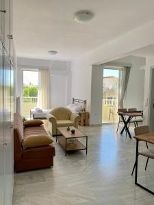 a living room with a couch and a table at Nearby Sea Studio in Rethymno
