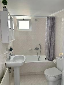 a bathroom with a sink and a toilet and a tub at Nearby Sea Studio in Rethymno +14 photos