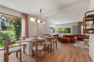 a dining room and living room with a table and chairs at - Villa Adonis - Luxe en charme in pittoresk De Haan in De Haan