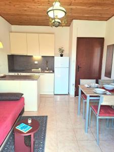 a kitchen and living room with a table and a couch at Apartmani Mirko App in Molat