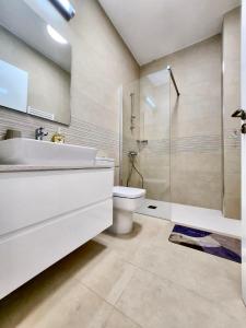 a bathroom with a sink and a toilet and a shower at Onero Residence Lovely Apartment in Paphos City