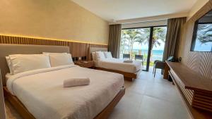 Ένα ή περισσότερα κρεβάτια σε δωμάτιο στο MantaHost Hotel